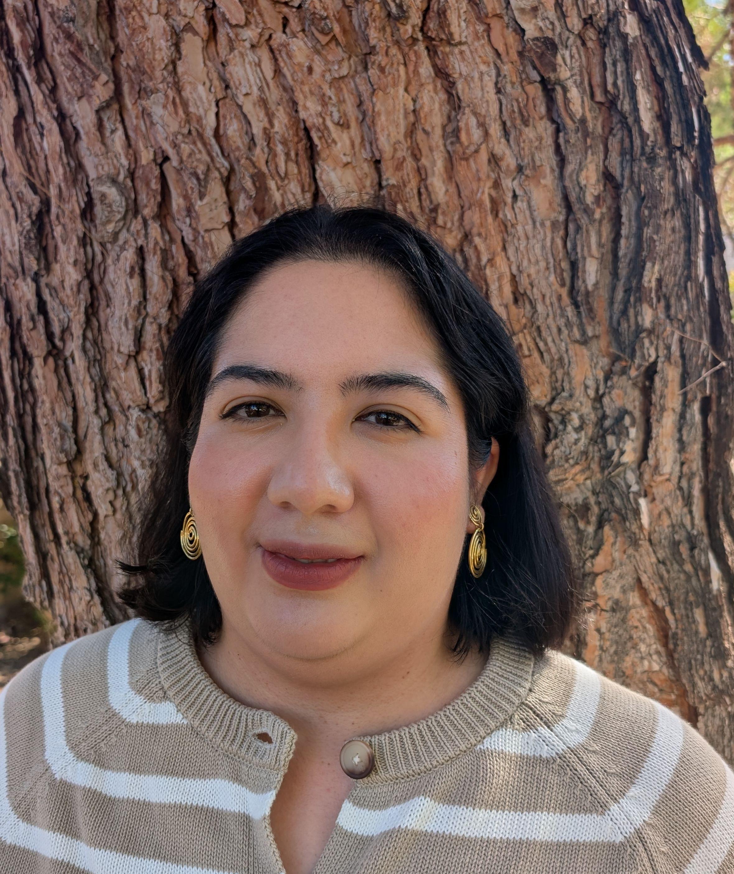 Image shows Vanessa with a background of tree.