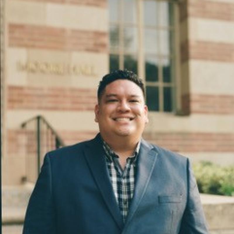 Man stands in front of a building